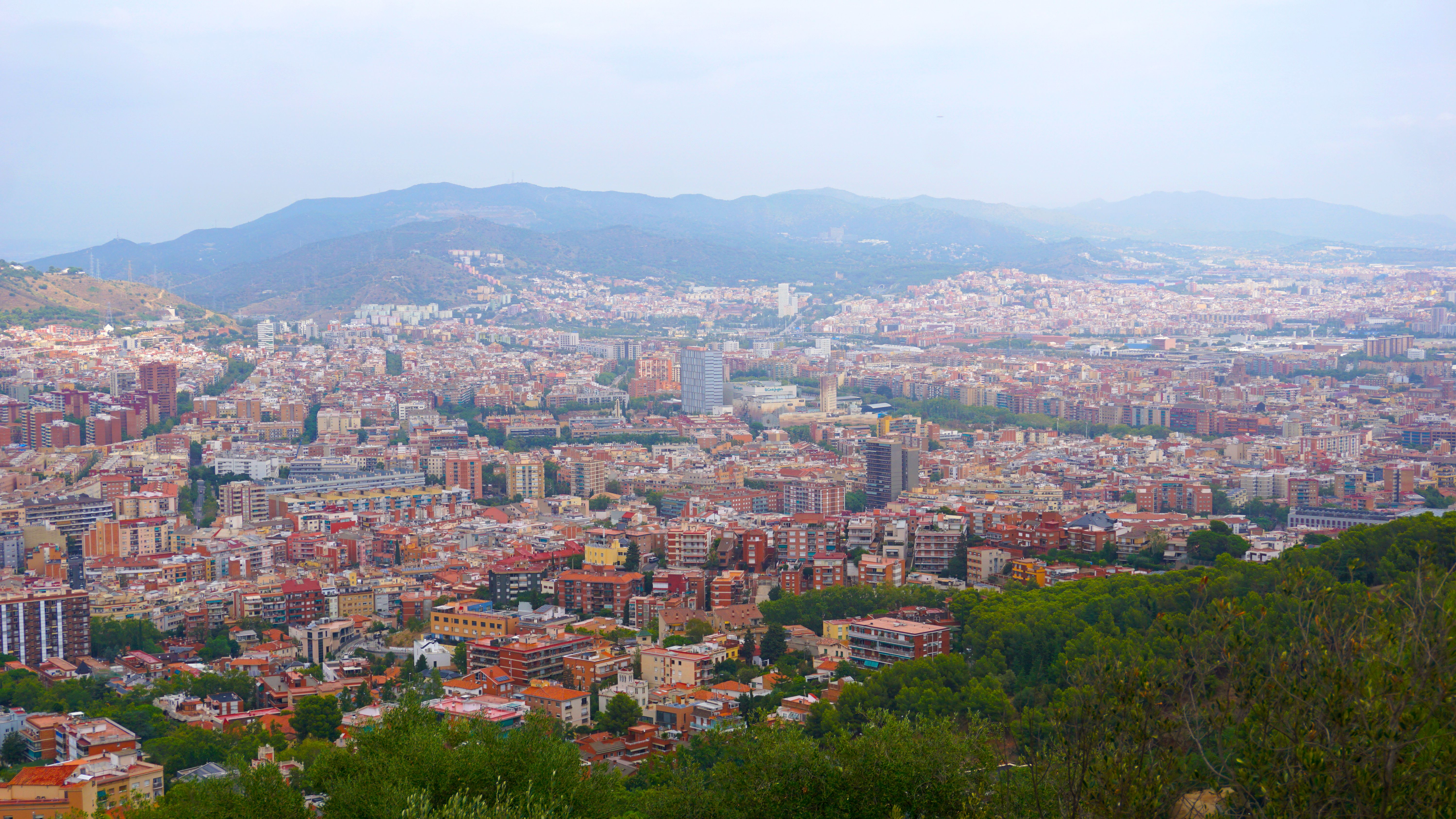 Incredible Barcelona Helicopter Flight, Winery Tour & Optional Sailing Trip Review 2026 - Explore a stunning aerial view of Barcelona, showcasing its vibrant architecture and mountainous backdrop.