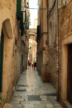 Explore the historic narrow streets of Split, Croatia, capturing its medieval charm and vibrant ambiance.