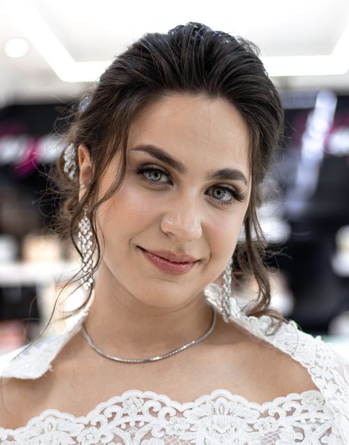 Free Elegant close-up of a bride with classic makeup, lace dress, and intricate hairstyle, showcasing a sophisticated look. Stock Photo