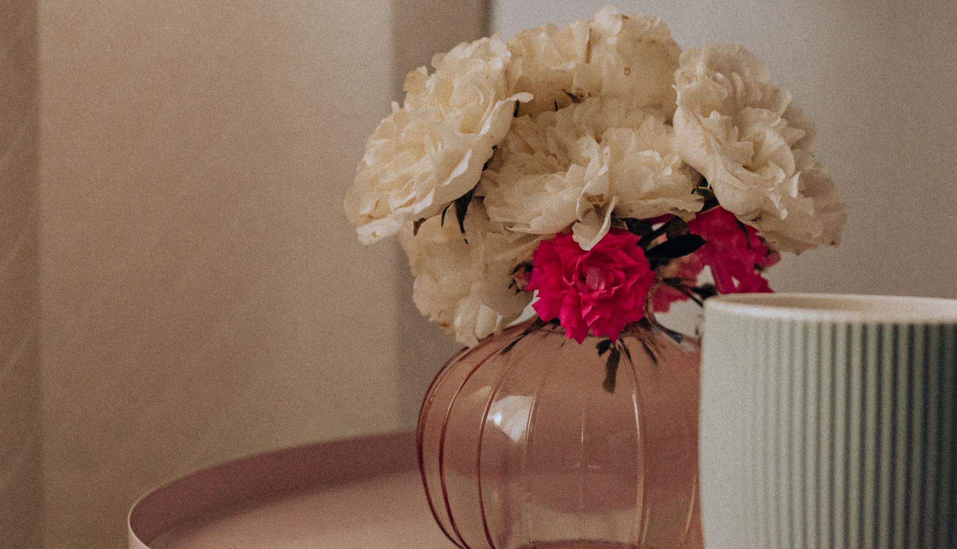 Aesthetic floral bouquet with white and pink flowers in a delicate glass vase.
