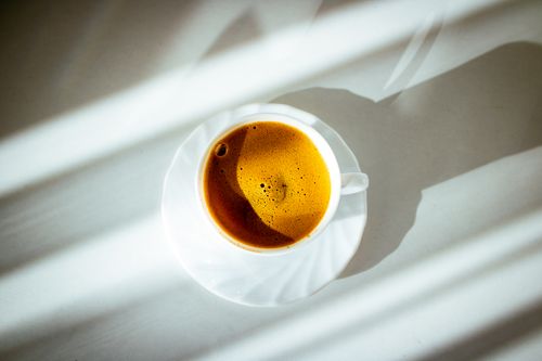 Free A vibrant shot of Turkish coffee in a sunlit cup, casting shadows. Stock Photo
