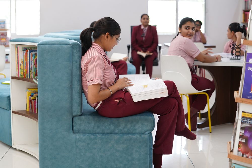 Students studying together in a modern library in Petlad, Gujarat, India