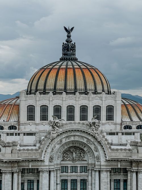 Free Stunning facade of Palacio de Bellas Artes, iconic Mexico City landmark under cloudy skies. Stock Photo