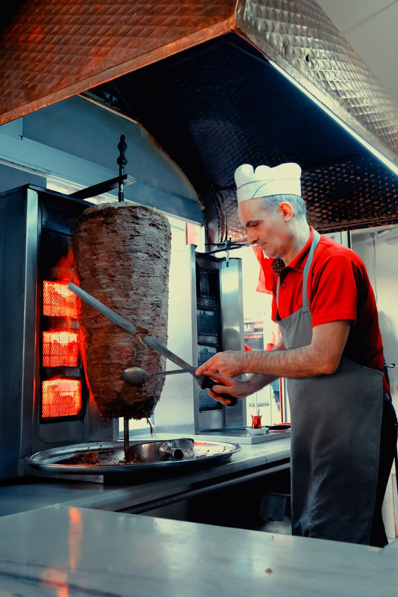 Chef preparing grilled meat in the kitchen