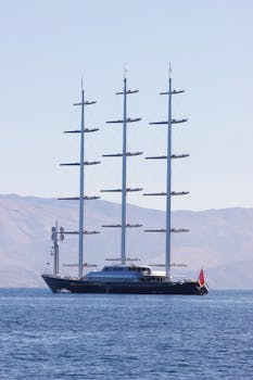 A stunning luxury yacht sails in the clear blue waters off the coast of Corfu, Greece.