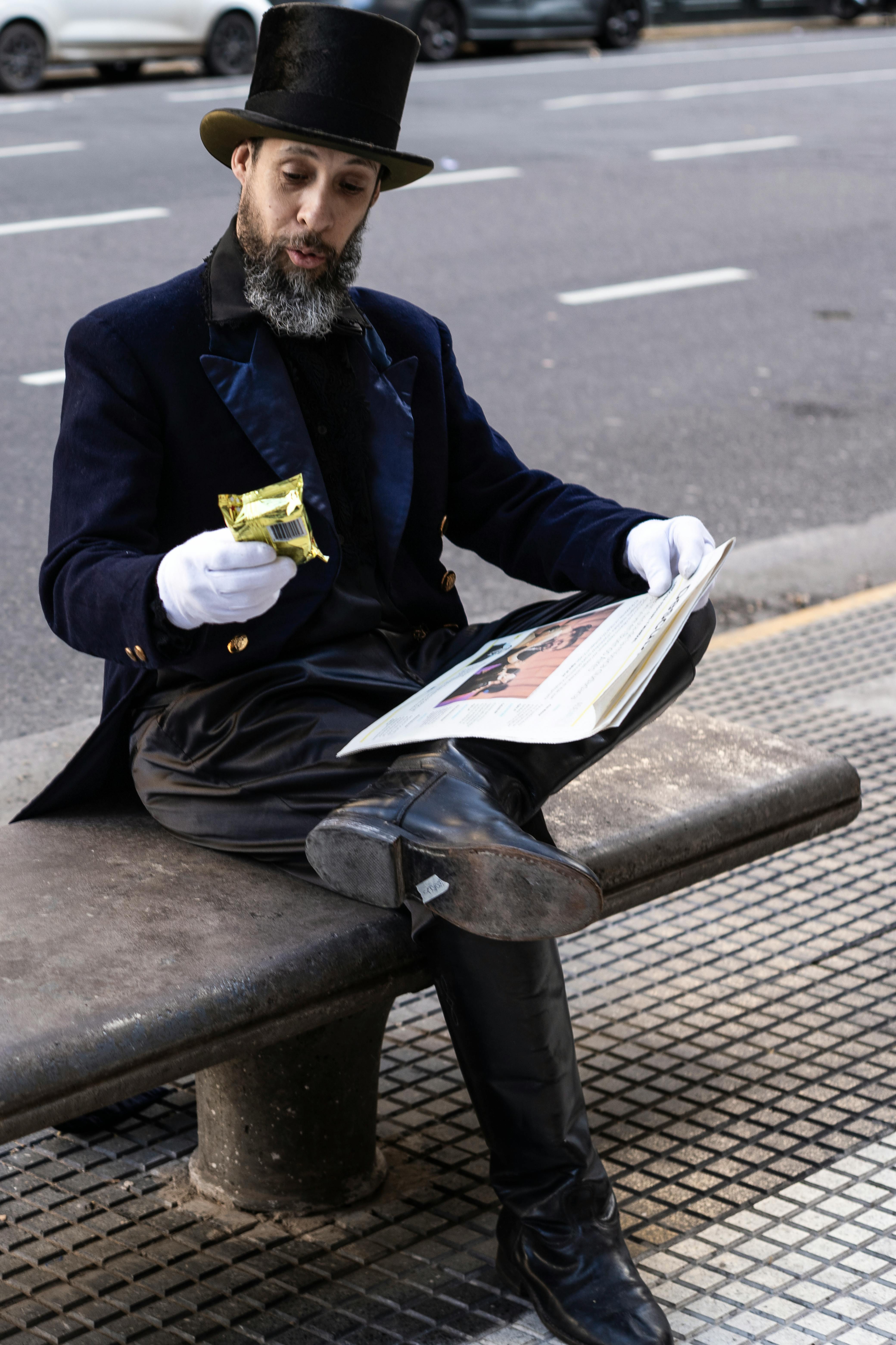 A stylish gentleman in Buenos Aires sits on a bench reading a newspaper, exuding classic sophistication.
