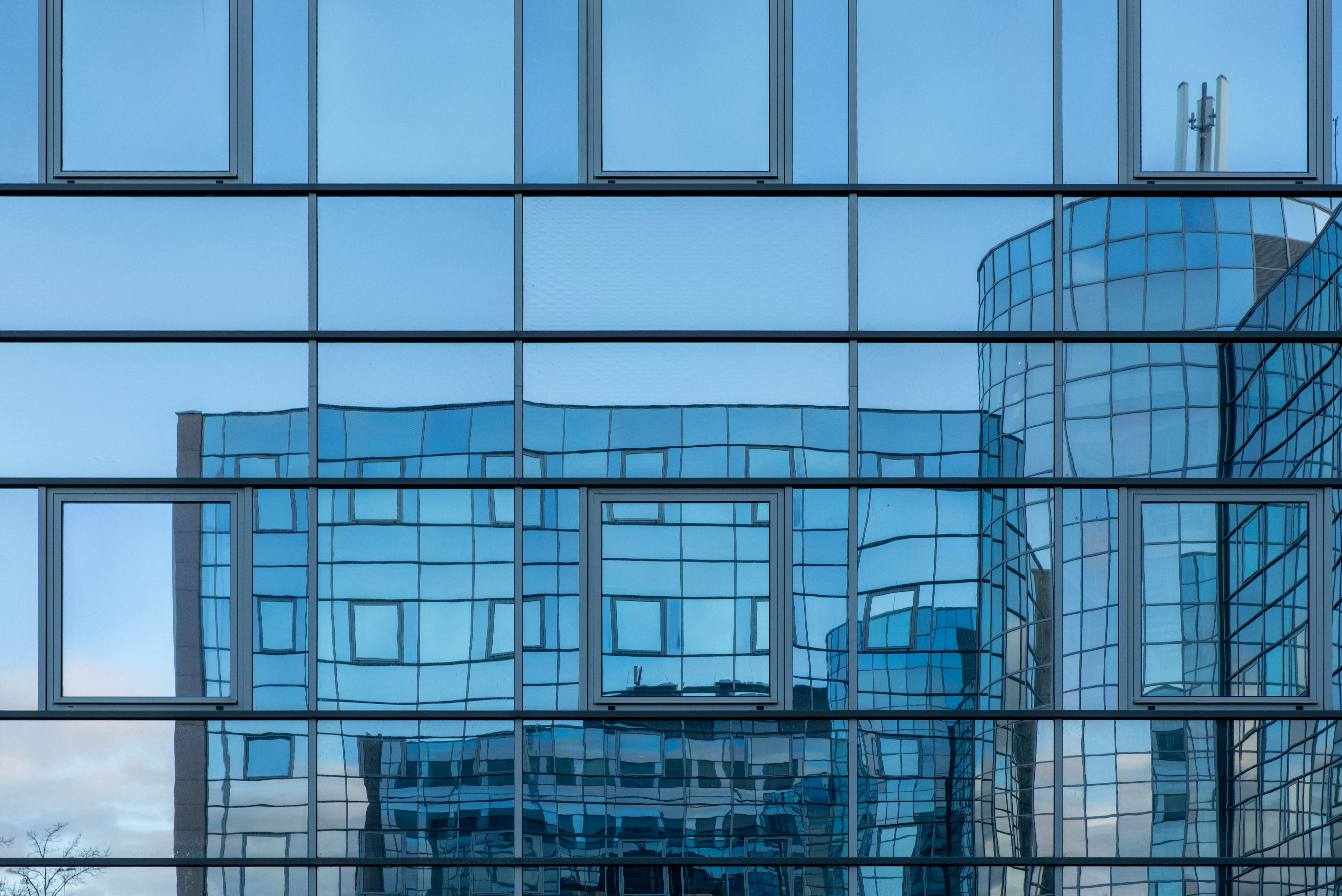 Modern Building Facade with Glass Reflection · Free Stock Photo
