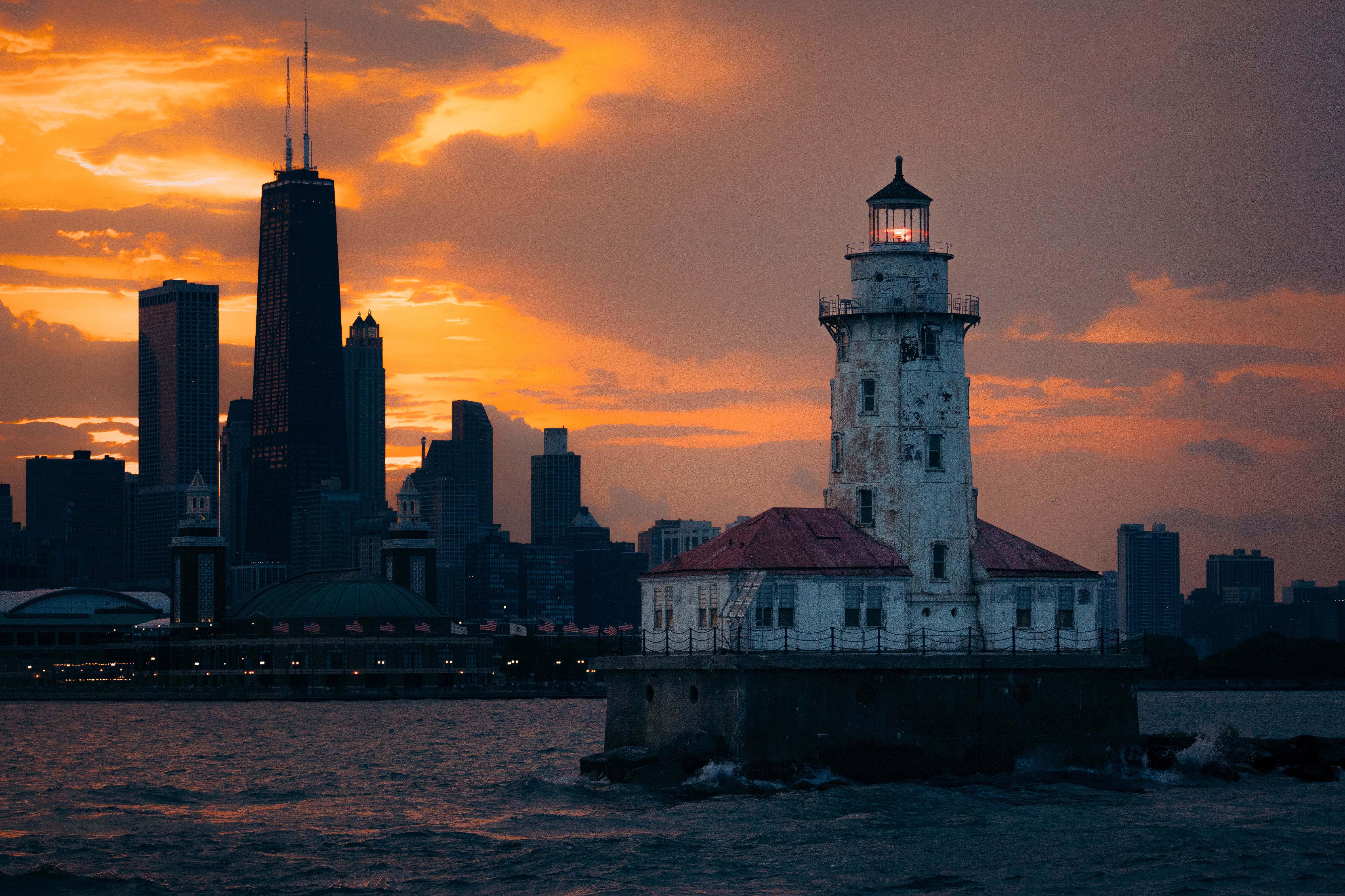 Stunning view of Chicago Harbor Lighthouse with city skyline at sunset. Stunning view of Chicago Harbor Lighthouse with city skyline at sunset.