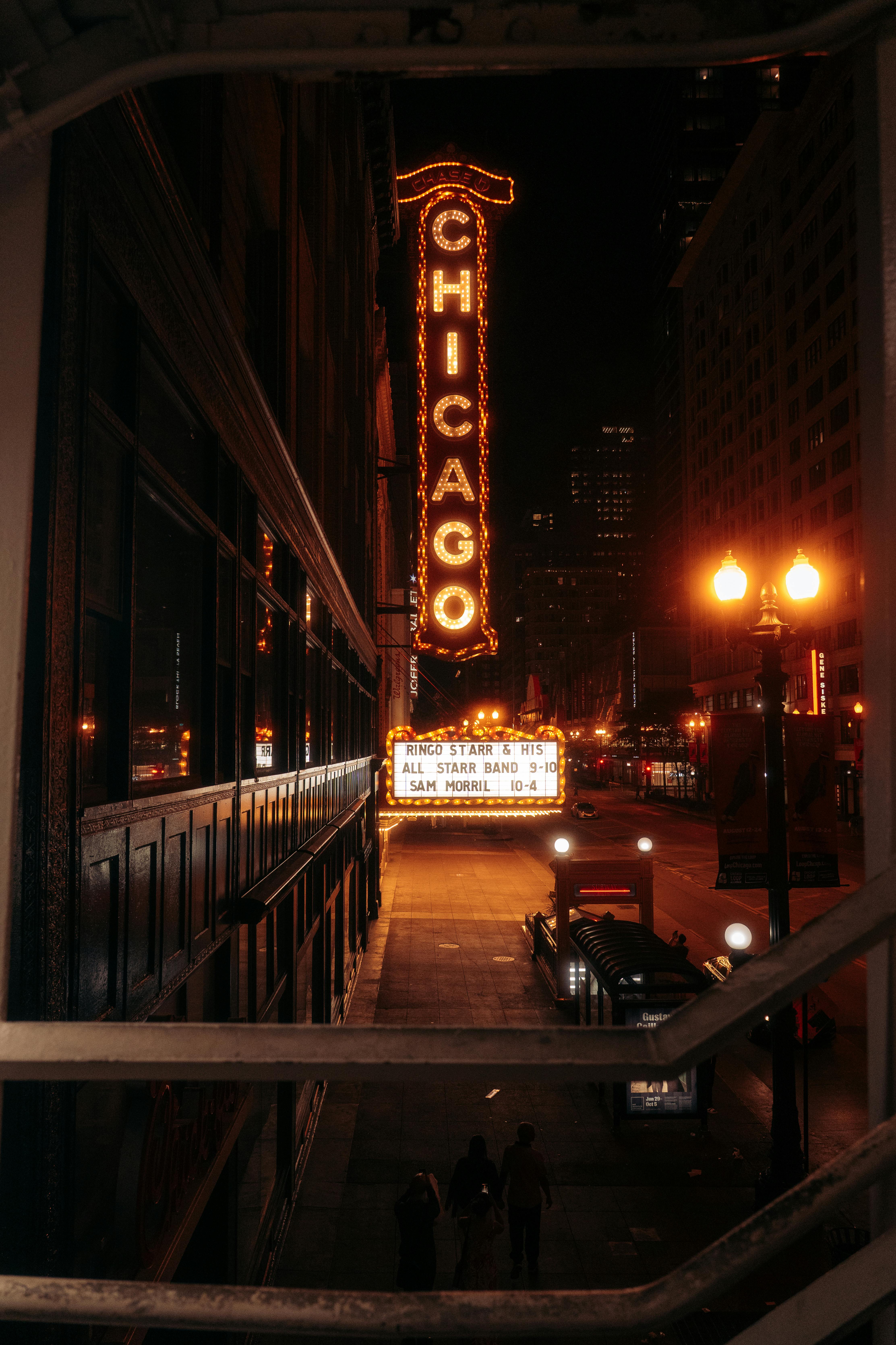 Free Iconic Chicago Theater lit up at night on a bustling street in Chicago. Stock Photo