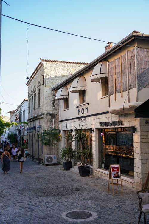 Free Picturesque cobblestone street with historic architecture and shops in a Mediterranean town. Stock Photo
