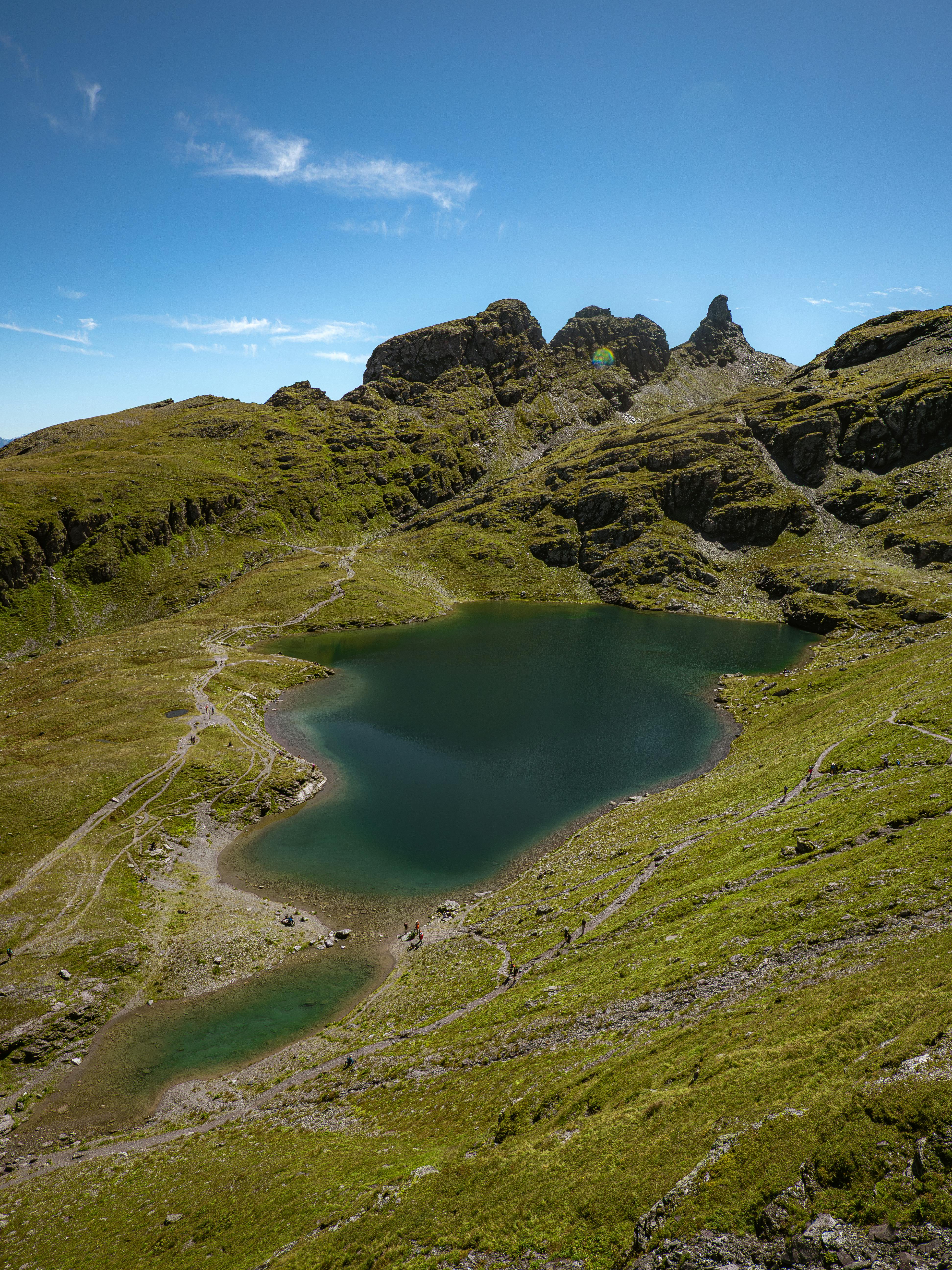 A breathtaking view of an alpine lake surrounded by rugged mountains in Mels, Sankt Gallen, Switzerland.