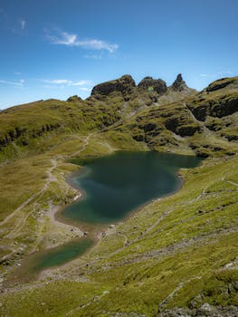 A breathtaking view of an alpine lake surrounded by rugged mountains in Mels, Sankt Gallen, Switzerland.