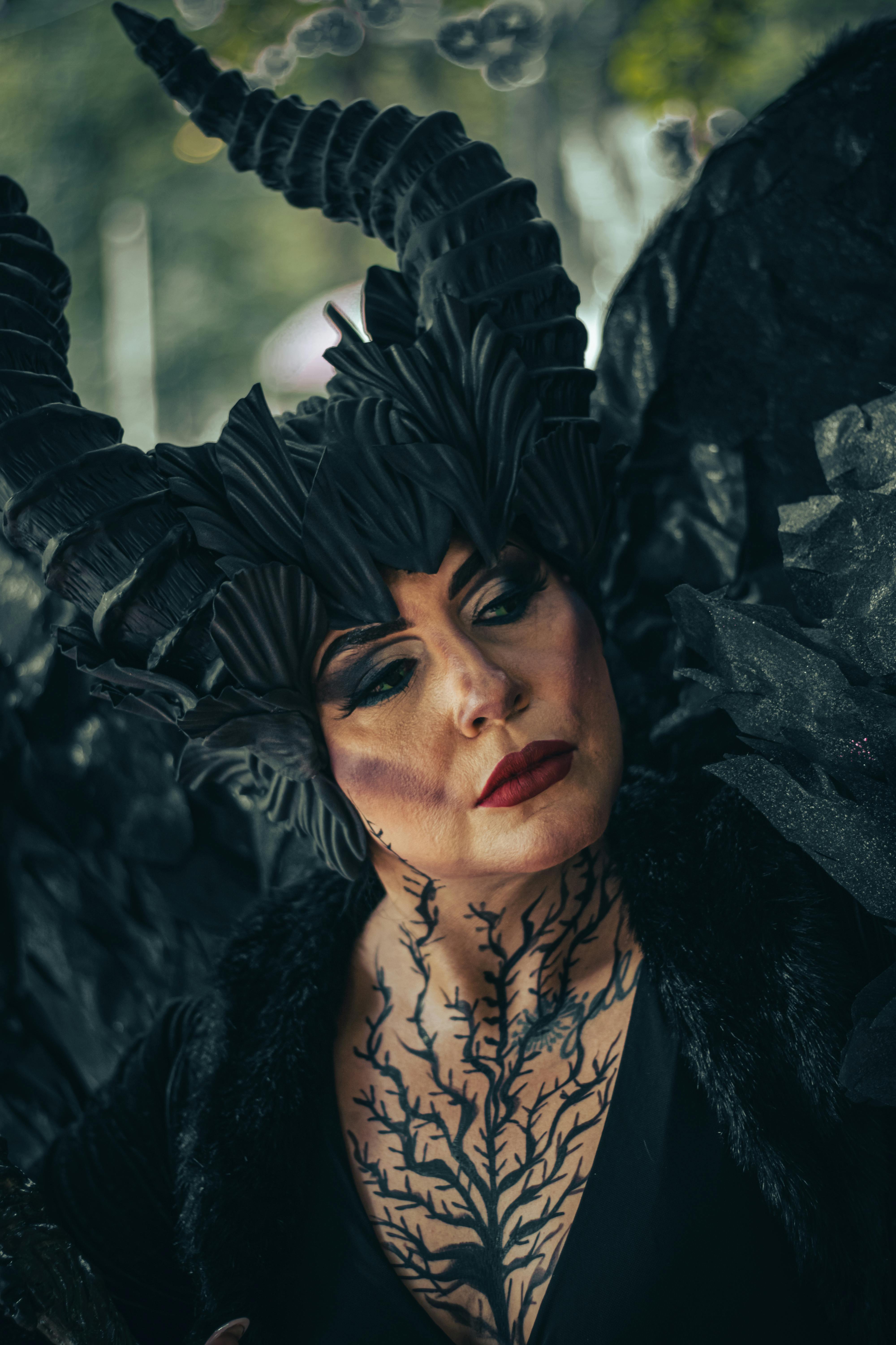 Free A woman in a fantasy costume with intricate dark makeup and horned headpiece, exuding mystery and creativity. Stock Photo