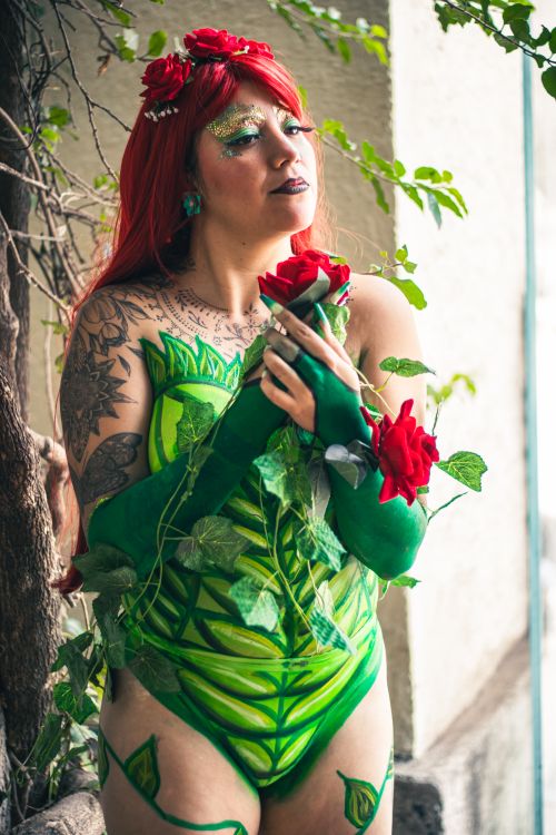 Free Creative cosplay of a vibrant character in a leafy costume with red hair, set outdoors. Stock Photo