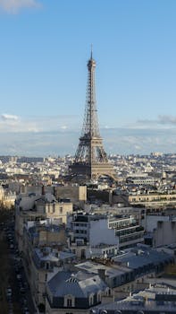 A captivating aerial view of the Eiffel Tower standing tall amidst Paris cityscape.
