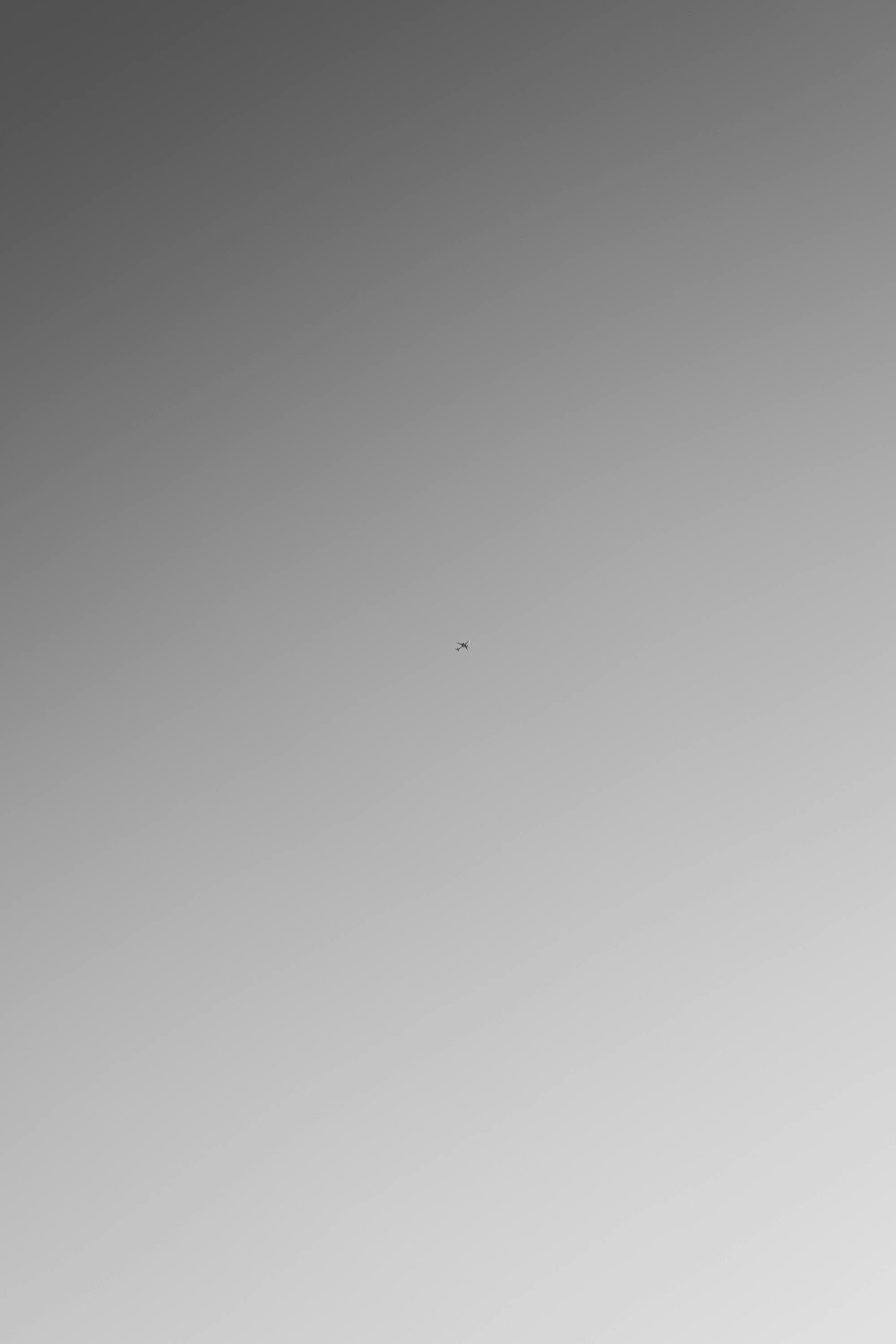 Free A small airplane captured in a minimalist scene with a clear blue sky, conveying a sense of freedom. Stock Photo