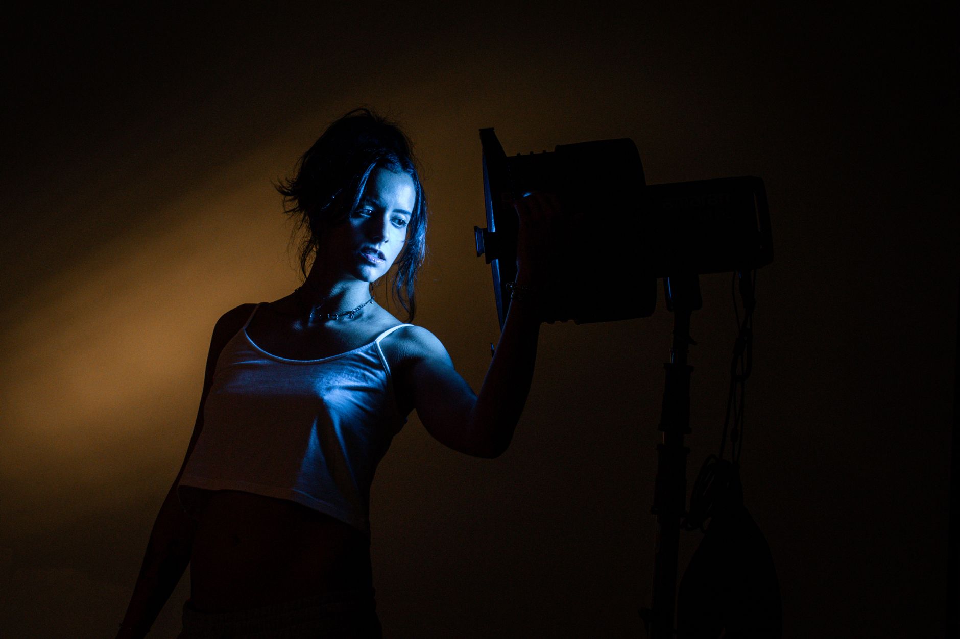 Artistic portrait of a woman in a photo studio using blue and yellow lighting.. artistic, portrait, woman