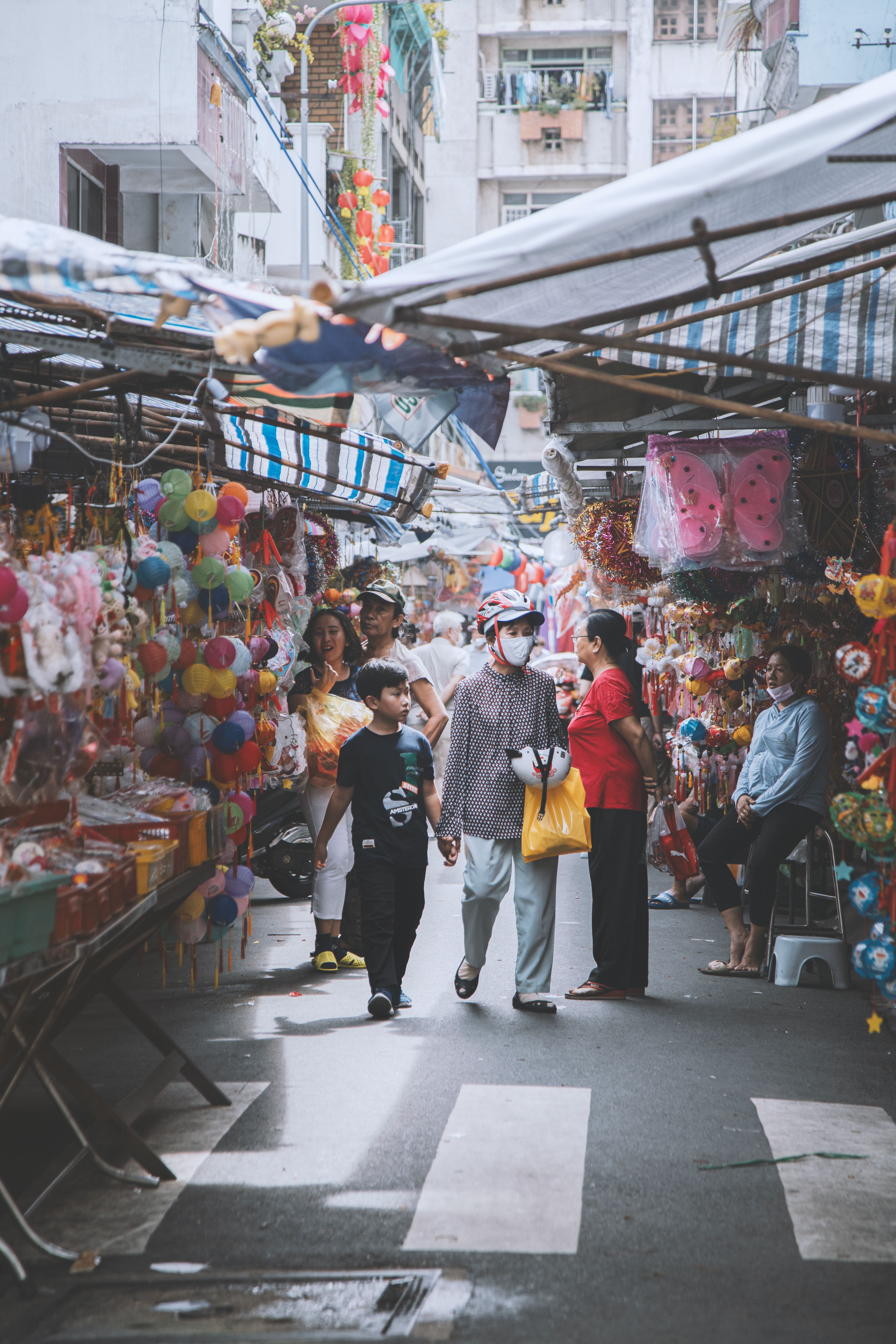 Captivating scene of a bustling Vietnamese street market, showcasing colorful lanterns and vibrant cultural festivities.
