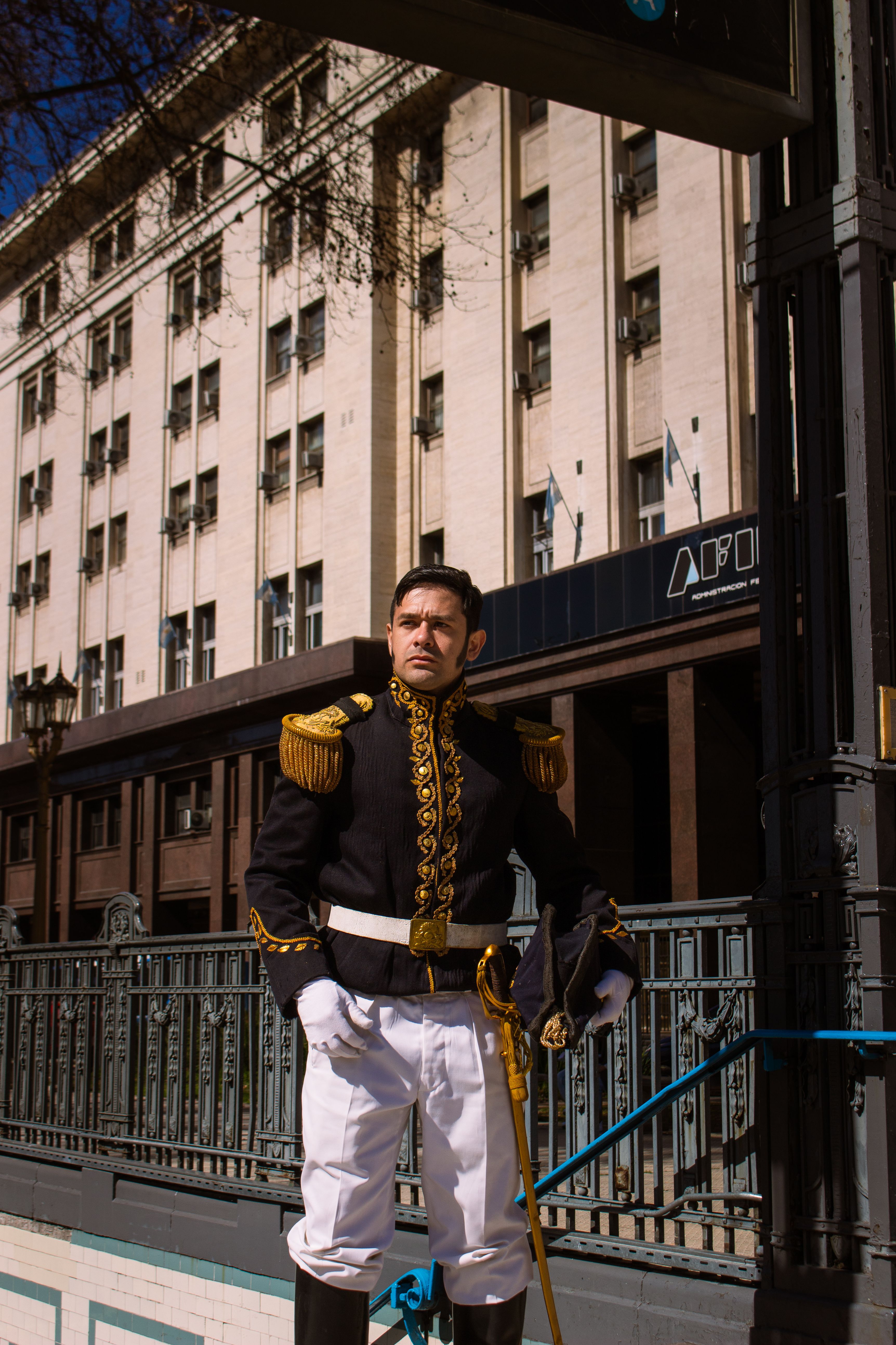 A uniformed guard stands outside a historic building in Buenos Aires, Argentina.