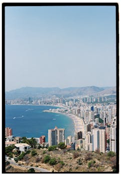 Stunning aerial view of Benidorm's iconic skyline and beach on a sunny day.