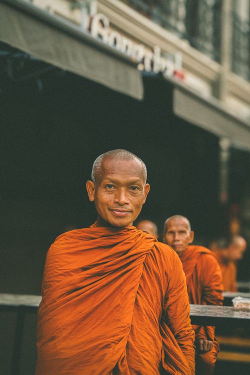 Free Portrait of monks in orange robes standing outdoors, showcasing traditional attire. Stock Photo