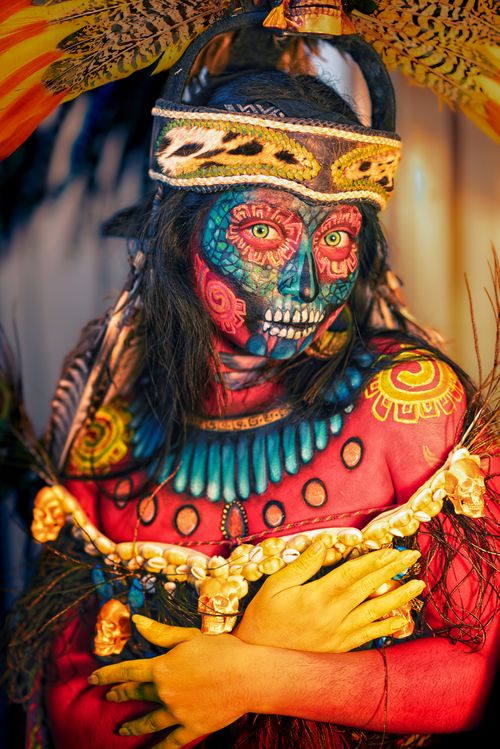 Free Colorful portrait of a person in traditional Day of the Dead costume and face paint. Stock Photo