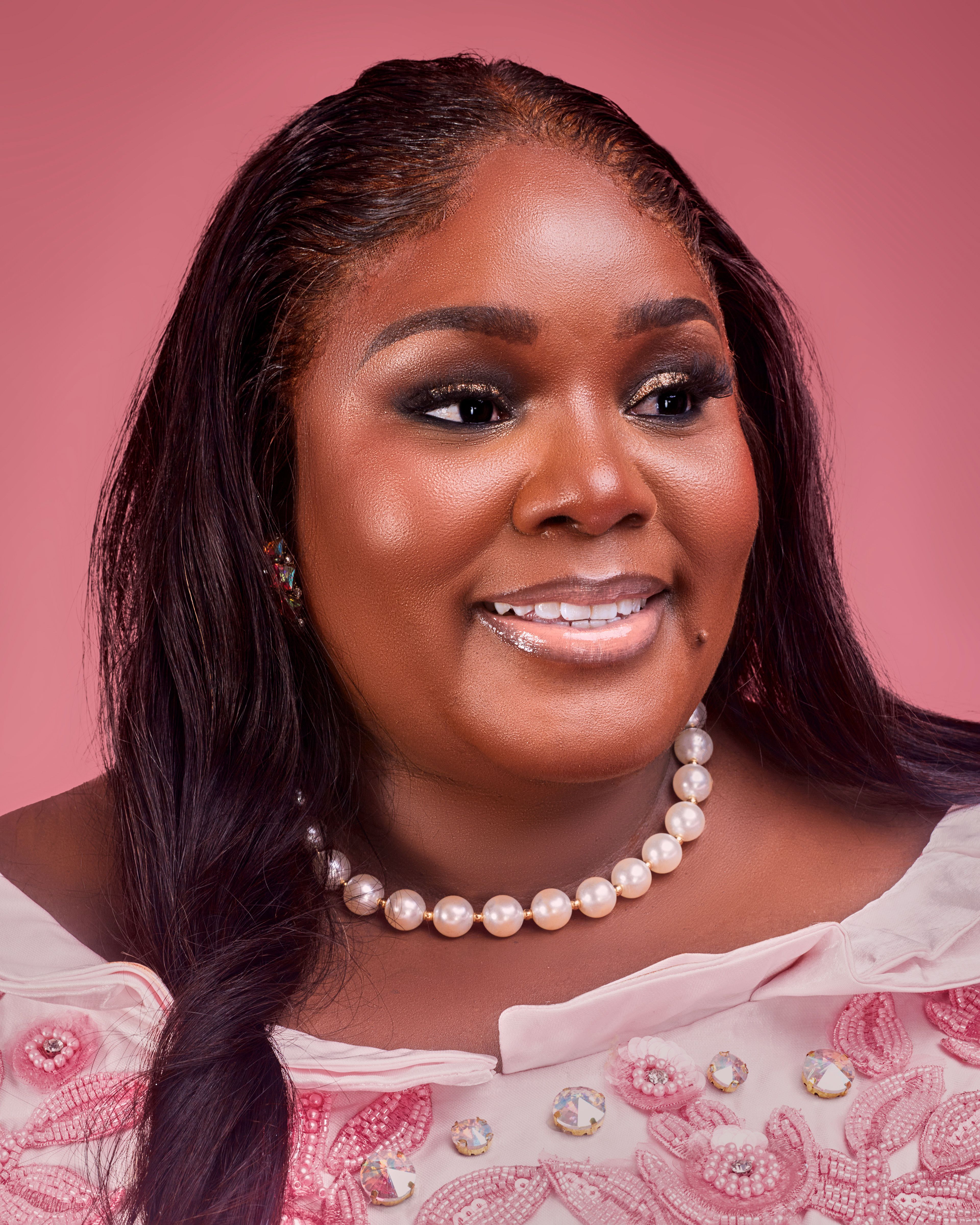 Charming portrait of a woman with a pearl necklace, exuding confidence and warmth.
