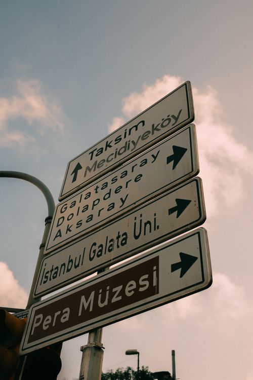 Free Directional signs in Istanbul pointing towards Taksim, Mecidiyekoy, and Pera Museum. Stock Photo