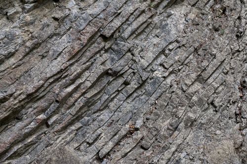 Free Detailed view of a rugged rock formation showcasing natural geological textures in the Swiss Alps. Stock Photo