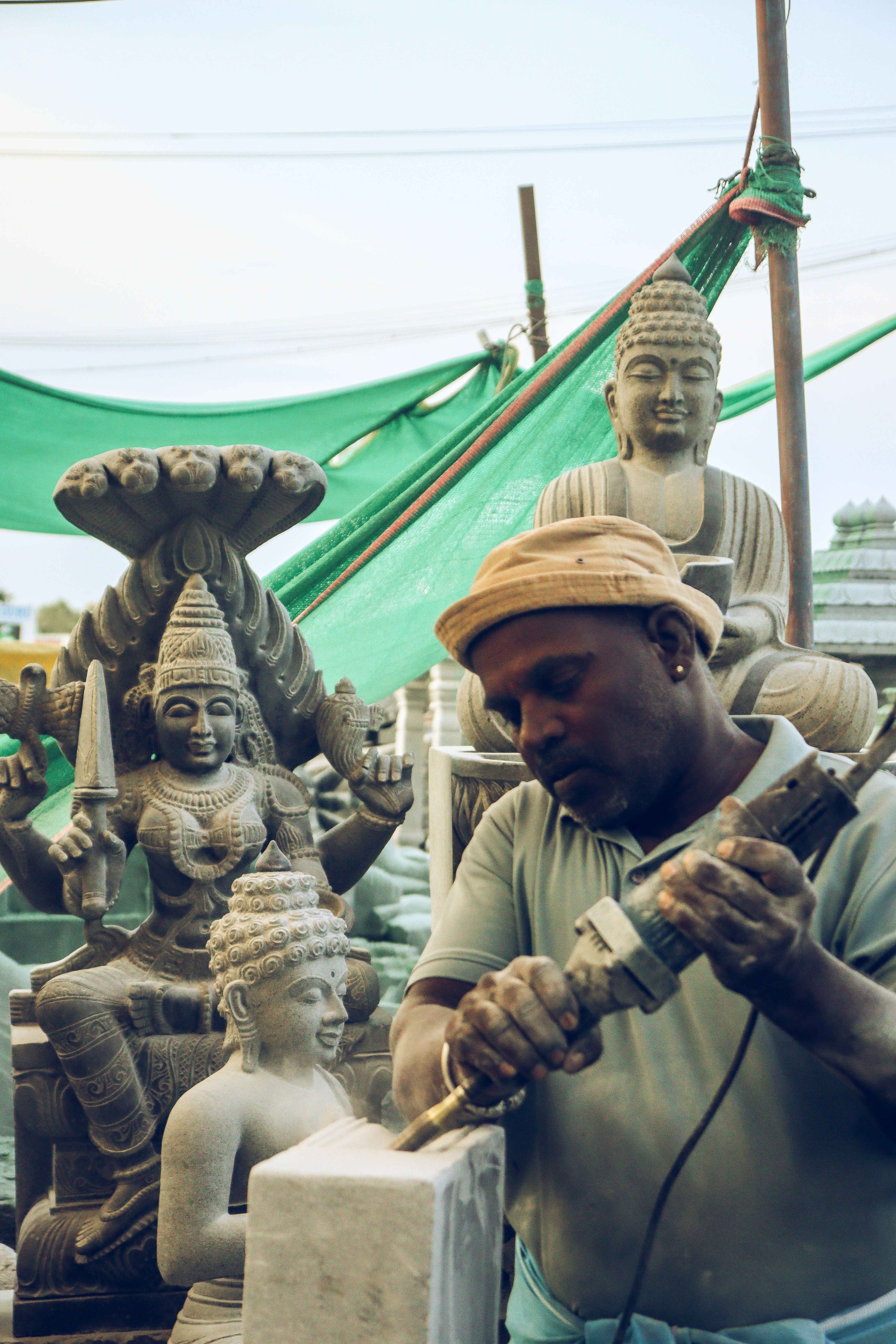Sculptor Crafting Stone Statues in Workshop · Free Stock Photo
