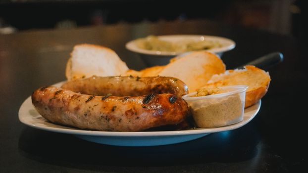 Grilled sausages with bread and mustard for an Oktoberfest-style meal