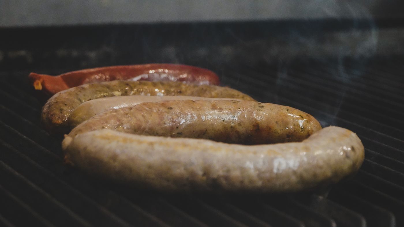 Sausages smoking on the grill