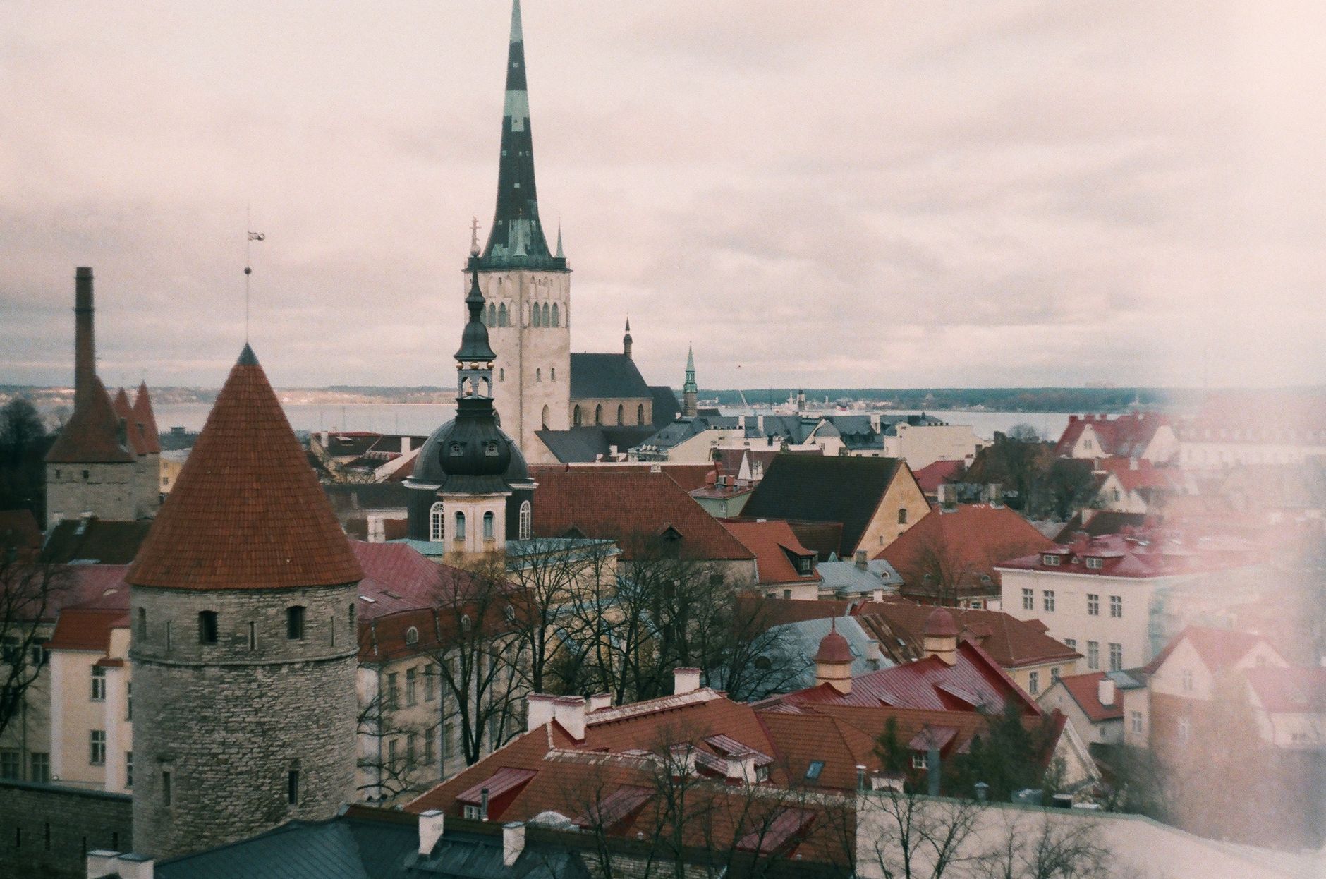 Charming view of Tallinn's medieval architecture and historic buildings under cloudy skies.