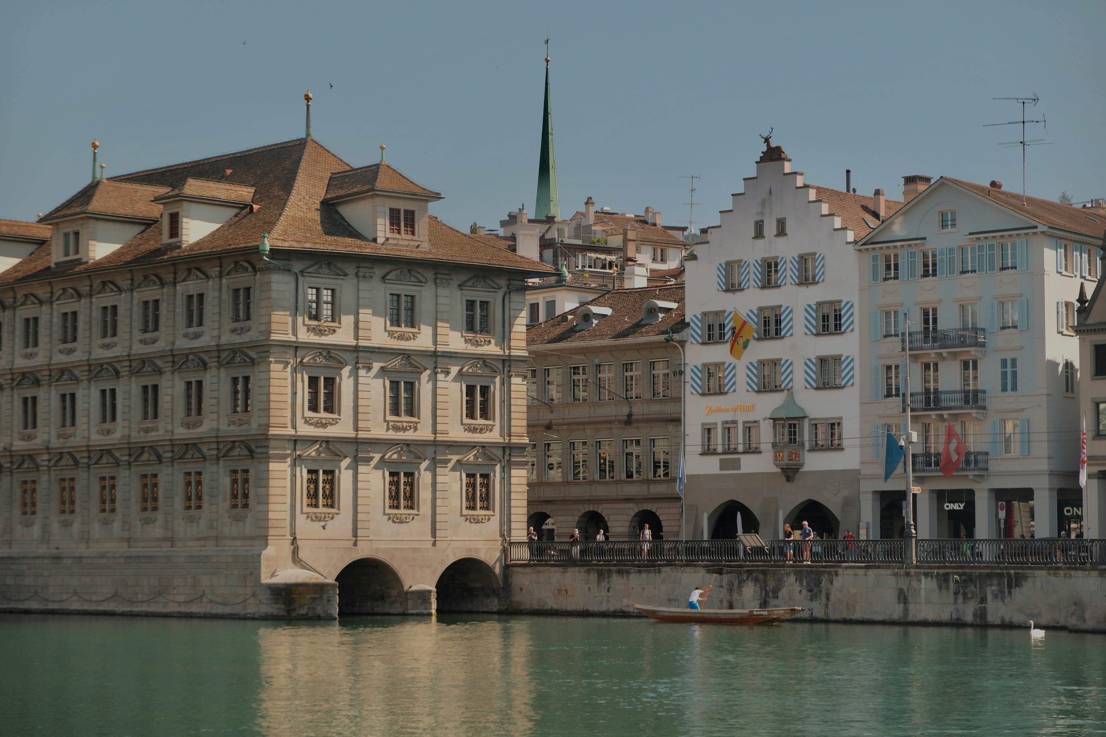 Scenic view of Zurich's historic buildings along the Limmat River, capturing Swiss architectural charm.