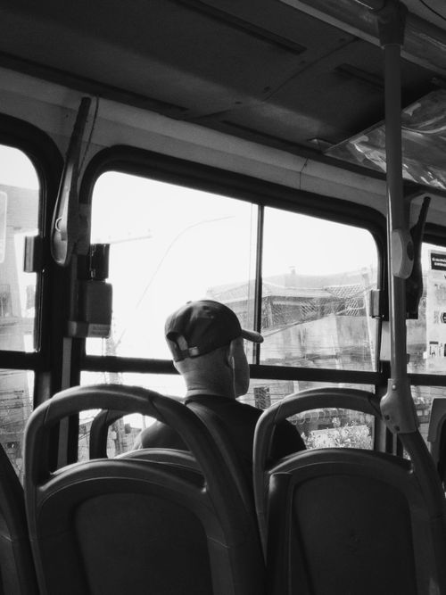 Free A contemplative moment captured in black and white from inside a bus in Belo Horizonte, Brazil. Stock Photo