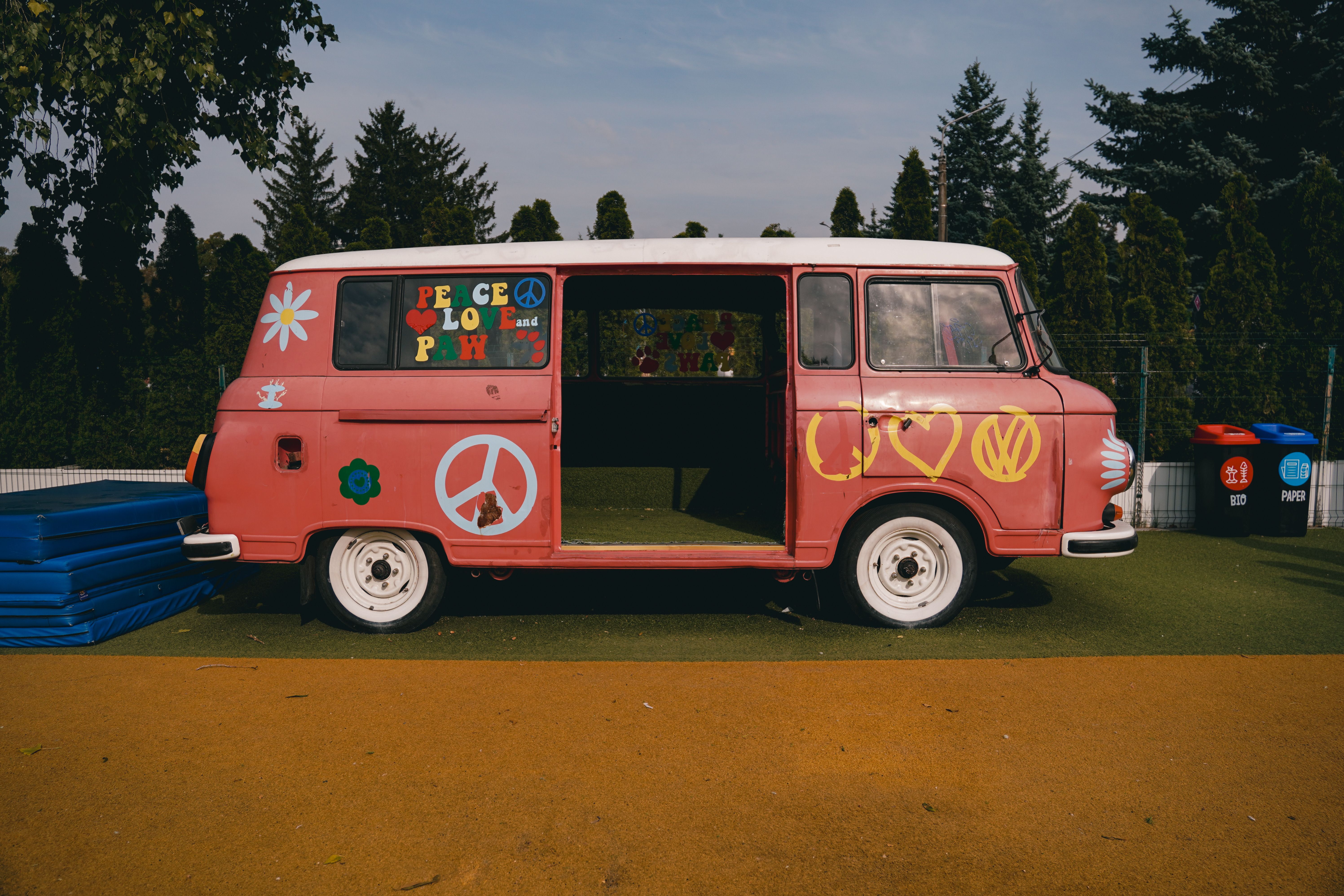 A colorful vintage van decorated with peace symbols parked outdoors in Kyiv, Ukraine.