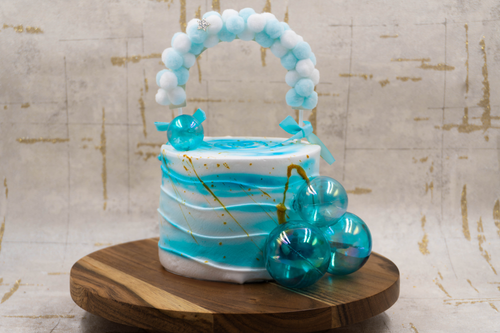 Free A beautifully crafted blue and white cake with decorative spheres, perfect for celebrations. Stock Photo