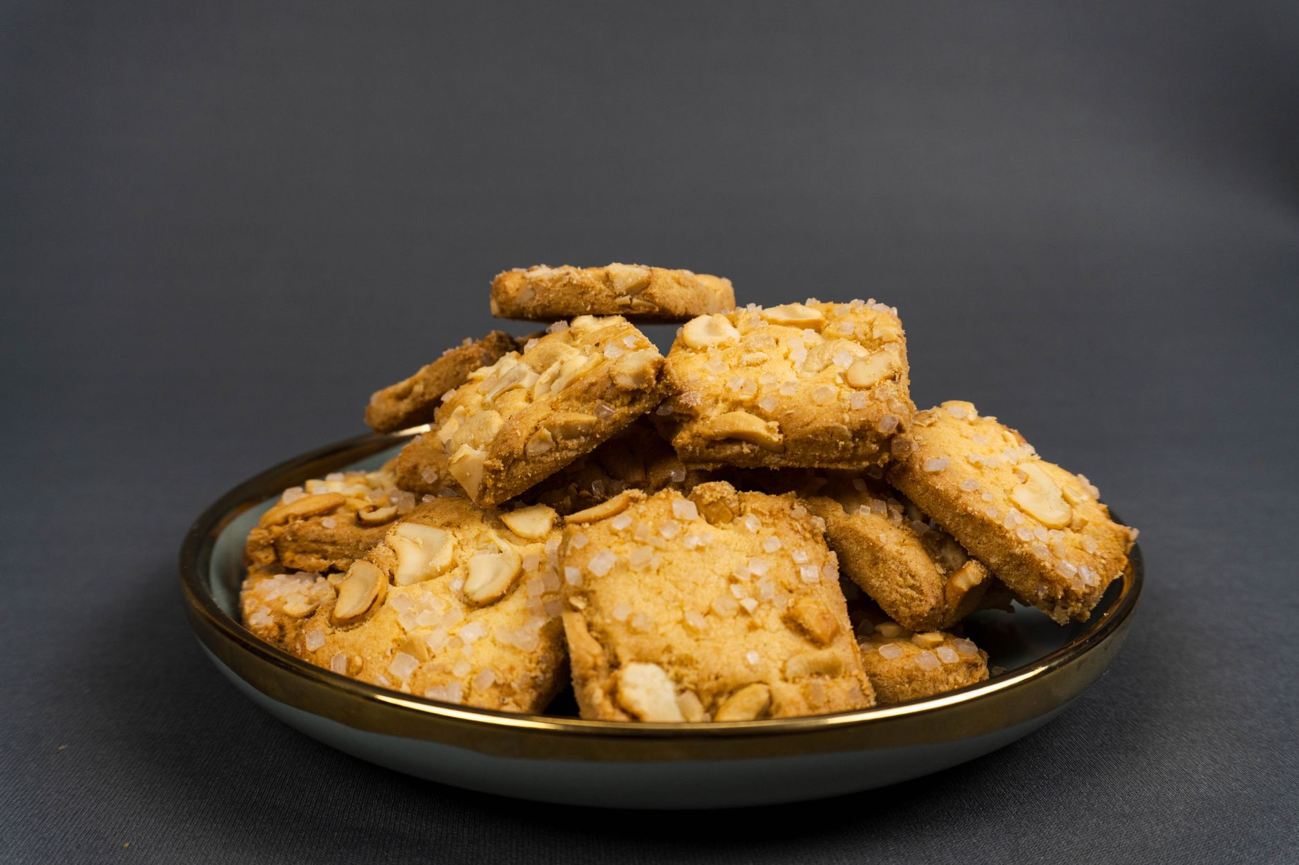 Freshly baked almond thins biscuits cooling on a rack