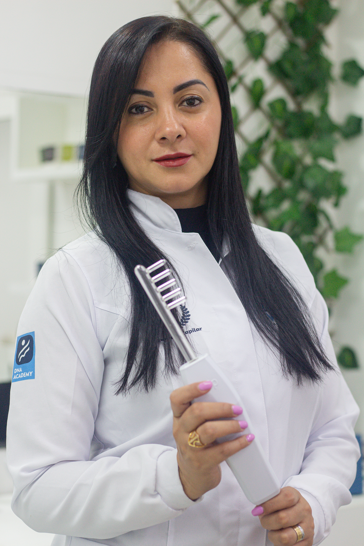 Hair and scalp professional holding a magnified hair-analysis tool