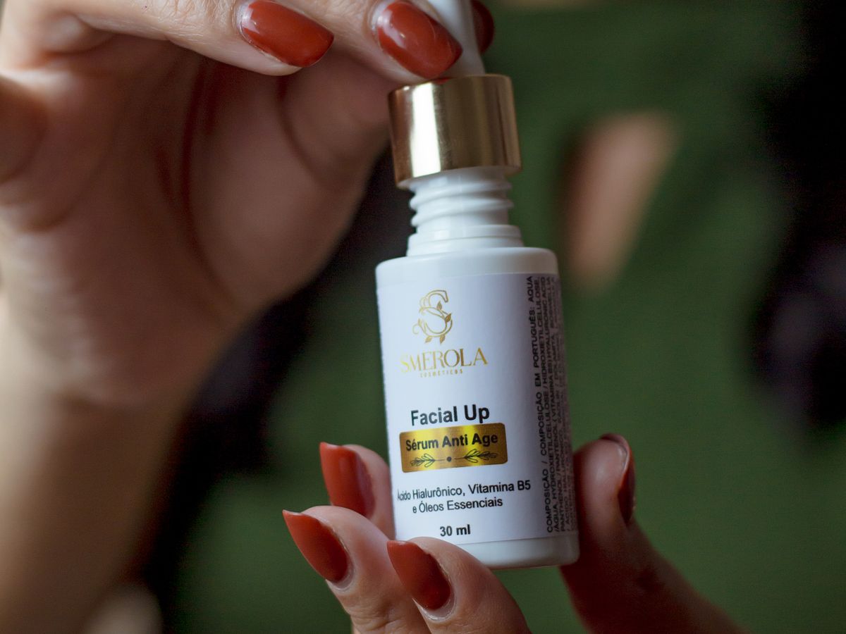 Woman holding a facial serum bottle