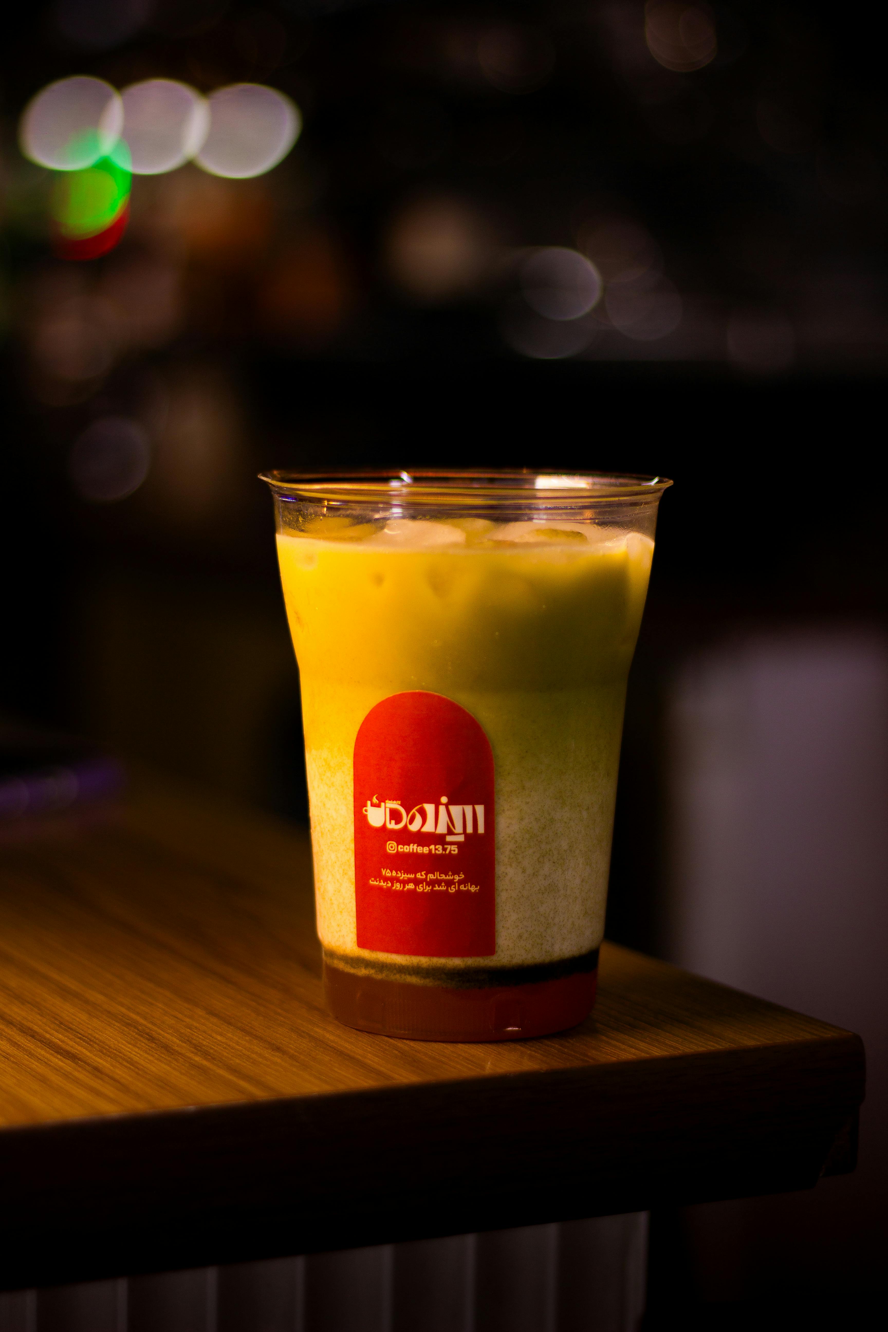 A chilled beverage with foam served in a brightly lit indoor setting. Perfect refreshment.