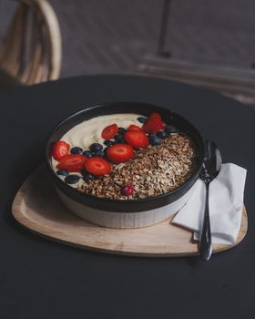 A delicious granola and berry bowl with yogurt, perfect for a healthy breakfast or brunch.