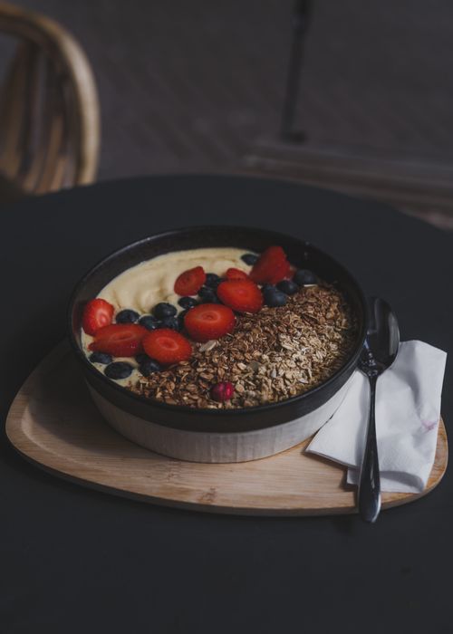 Free Delicious breakfast bowl with yogurt, strawberries, blueberries, and granola. Stock Photo