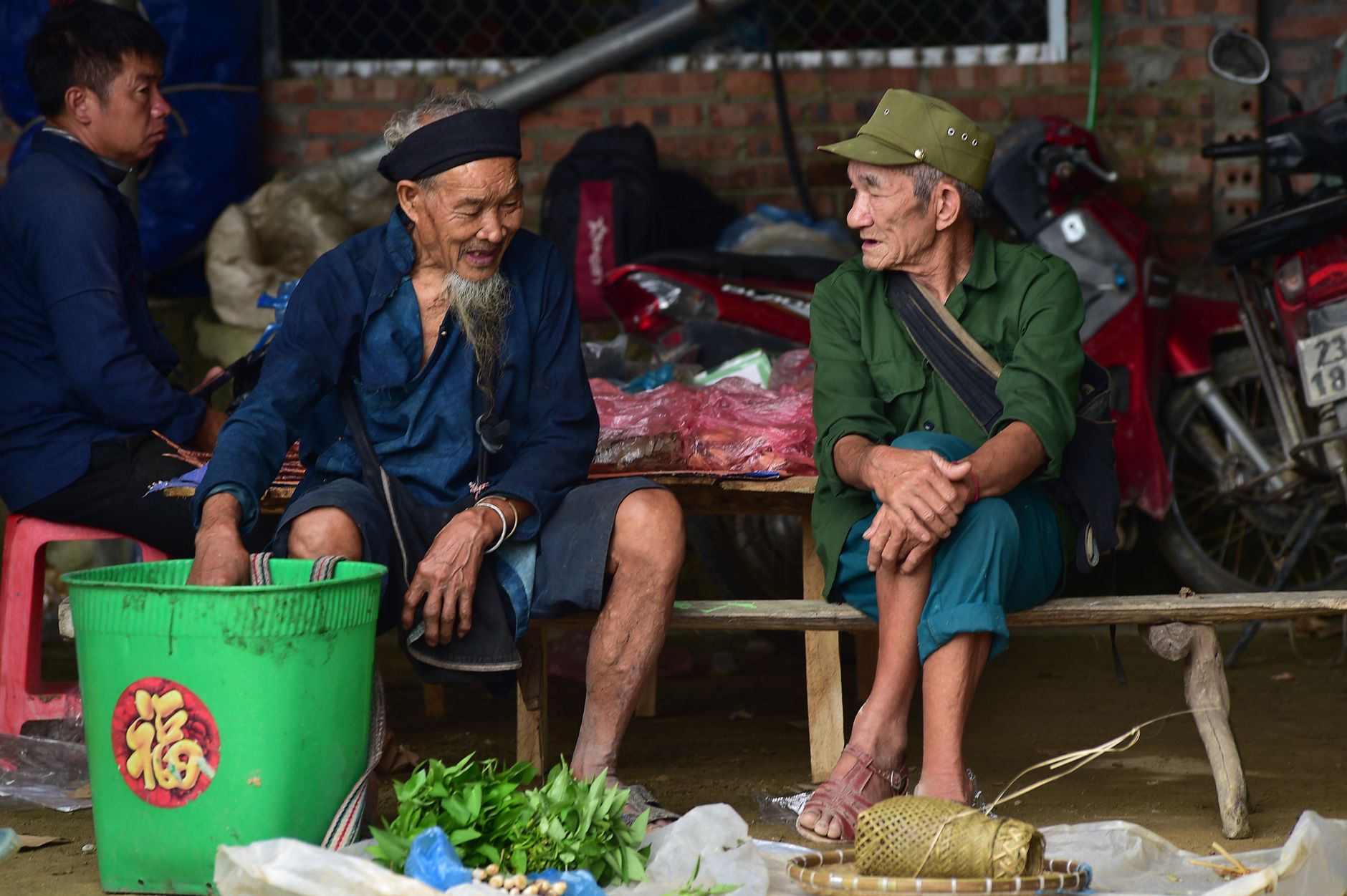 rural Vietnamese gathering space with empty ring barriers, early morning light and no spectators
