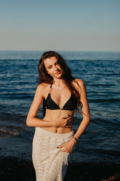 Free Smiling woman on a beach in a bikini enjoying the sunny weather. Stock Photo
