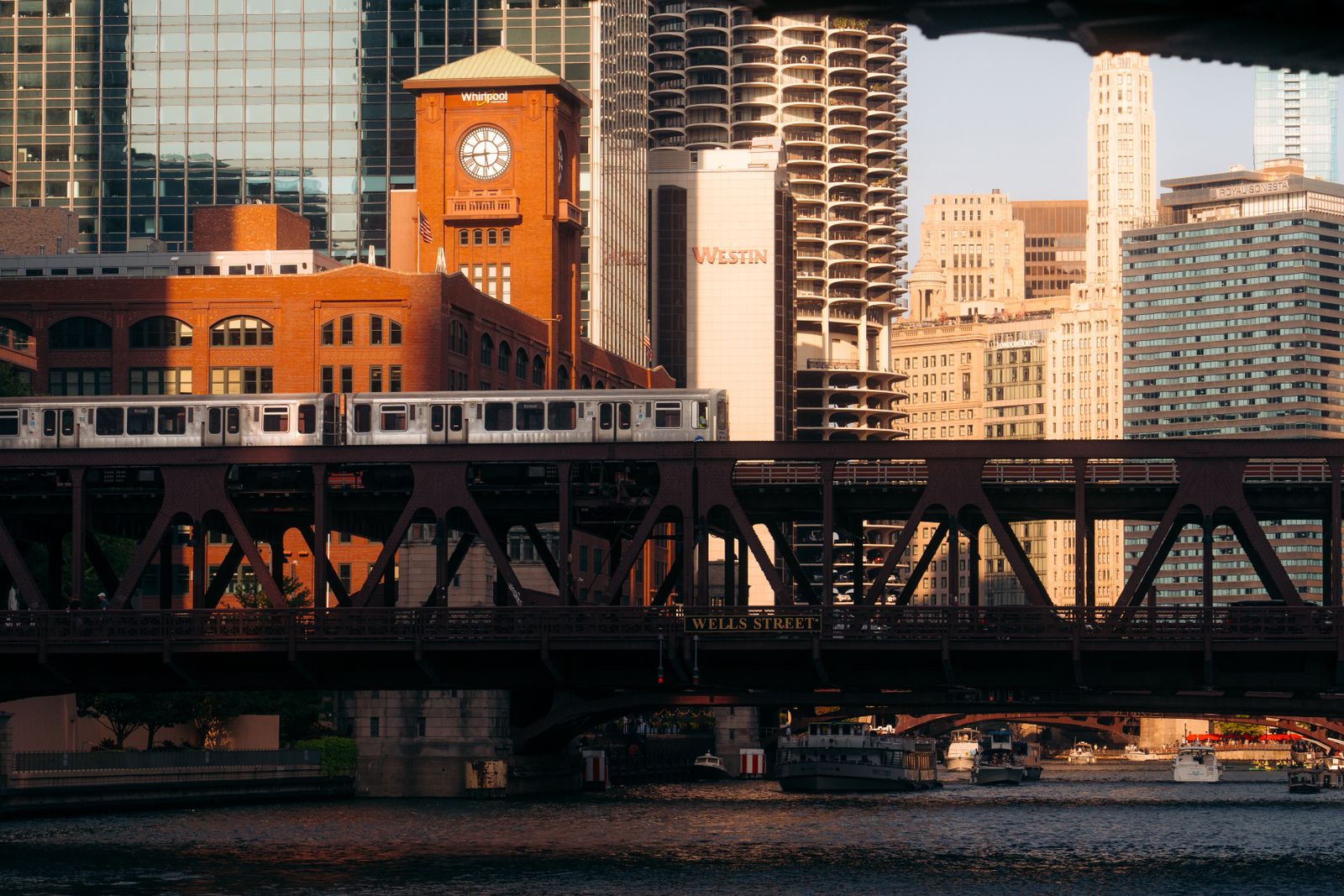 Chicago elevated train crossing Wells Street Bridge at sunset