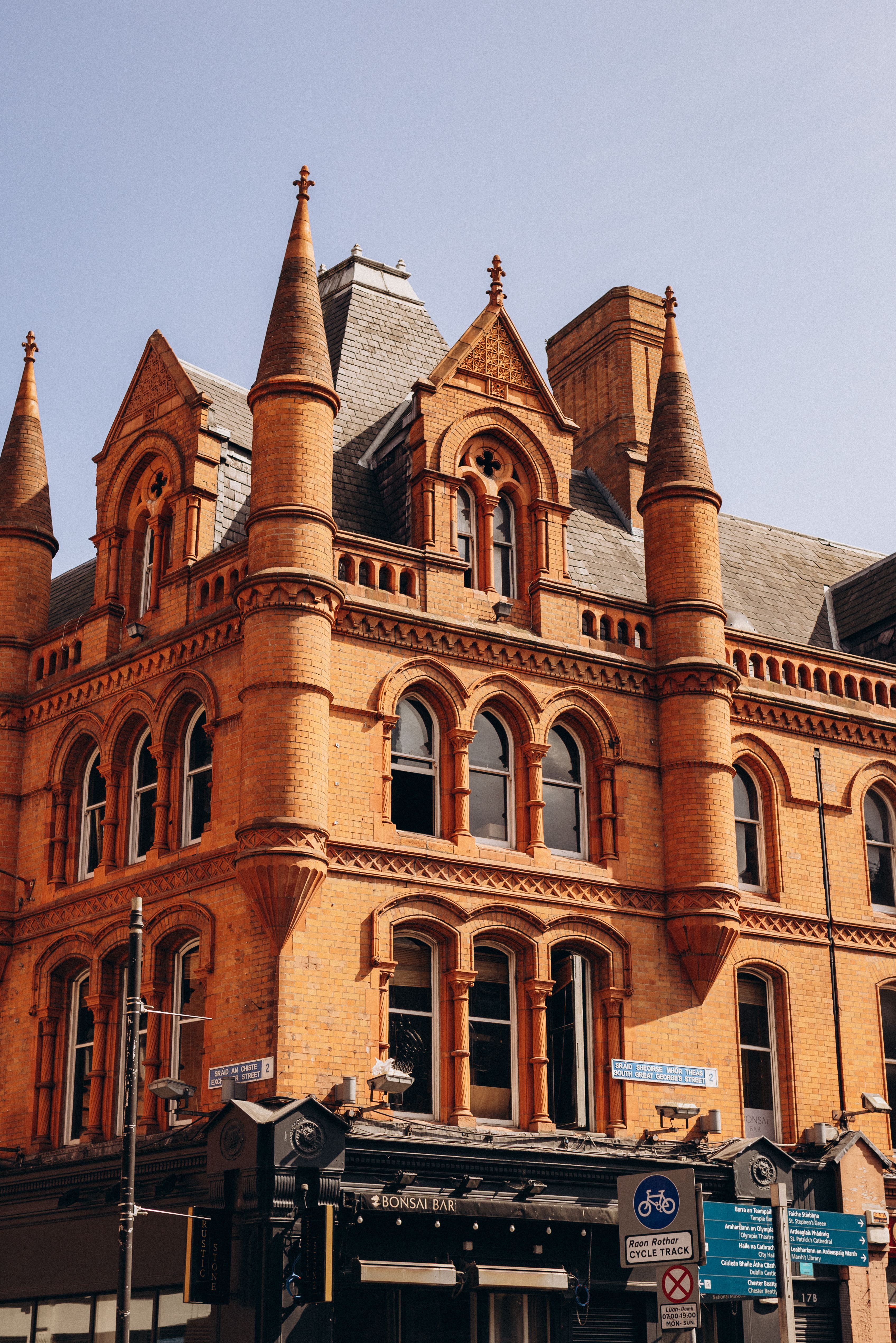 Stunning view of historic reddish-brown brick building in Dublin with Gothic revival architecture.