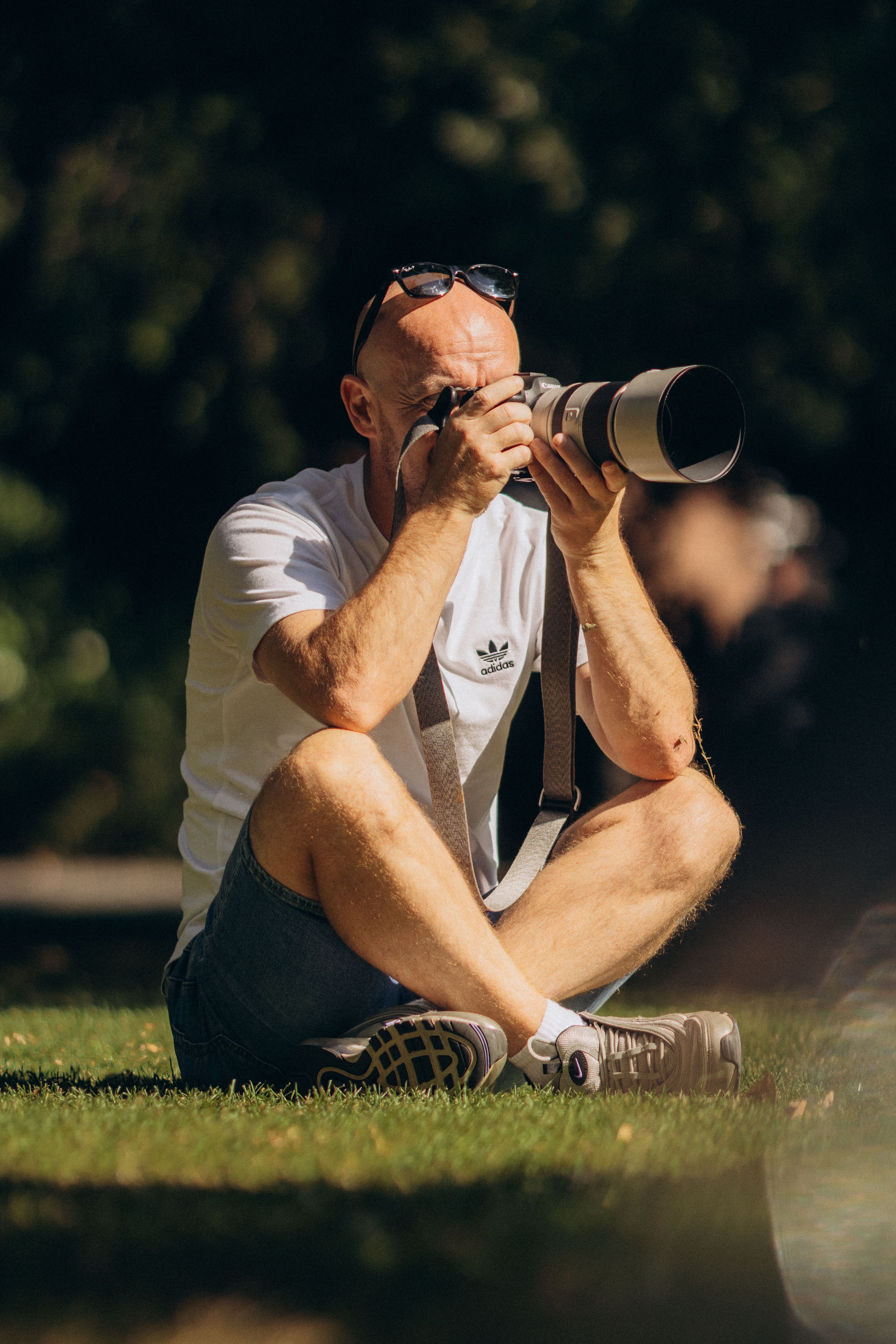 A photographer in Dublin, Ireland, capturing moments with a zoom lens on a sunny day.