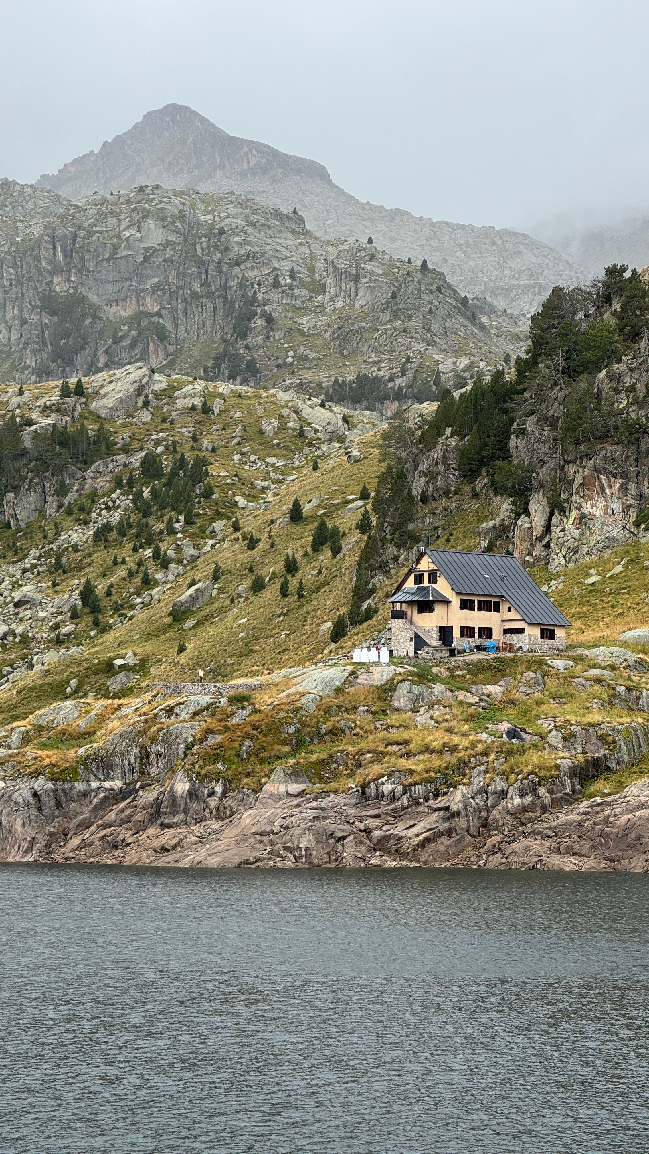 Idyllic mountain lodge by a serene lake in Catalonia, Spain. Perfect escape for nature lovers.