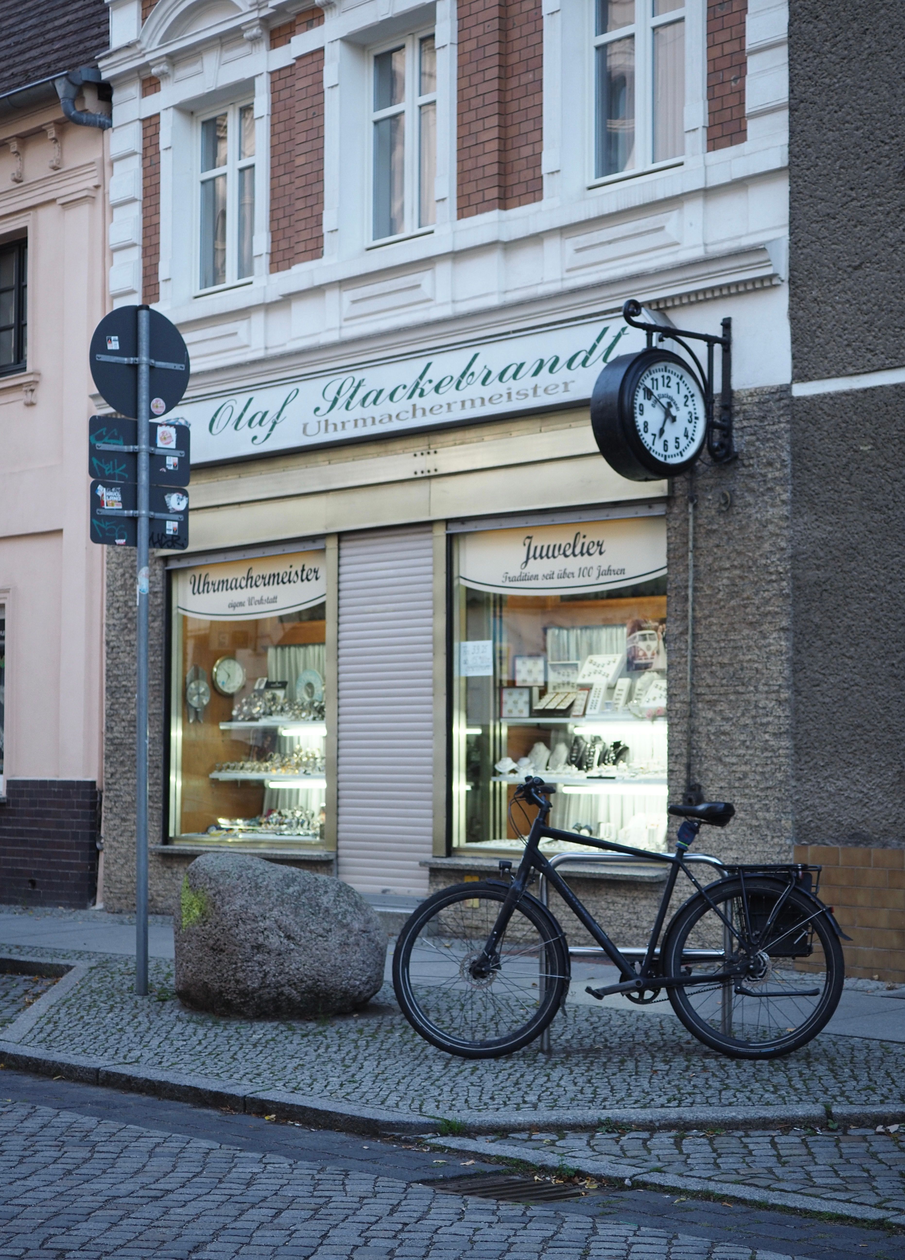 A vintage watch shop in Germany with a bicycle parked outside.